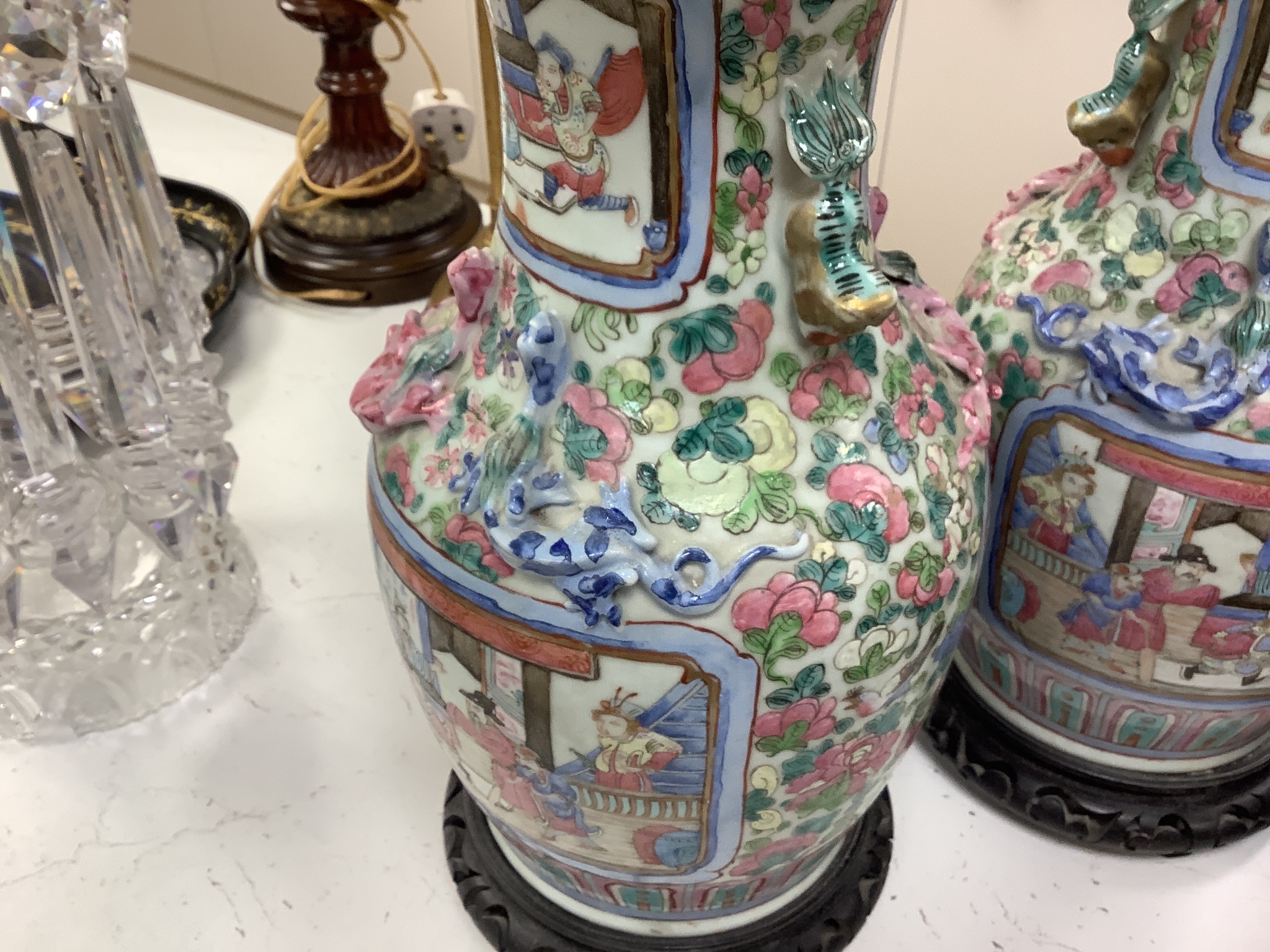 A pair of 19th century Chinese famille rose baluster vases, fitted as table lamps, on hardwood stands